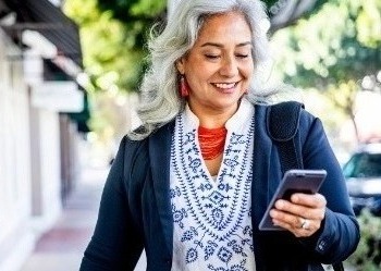 Woman walking using phone.