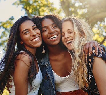 Three friends hugging.