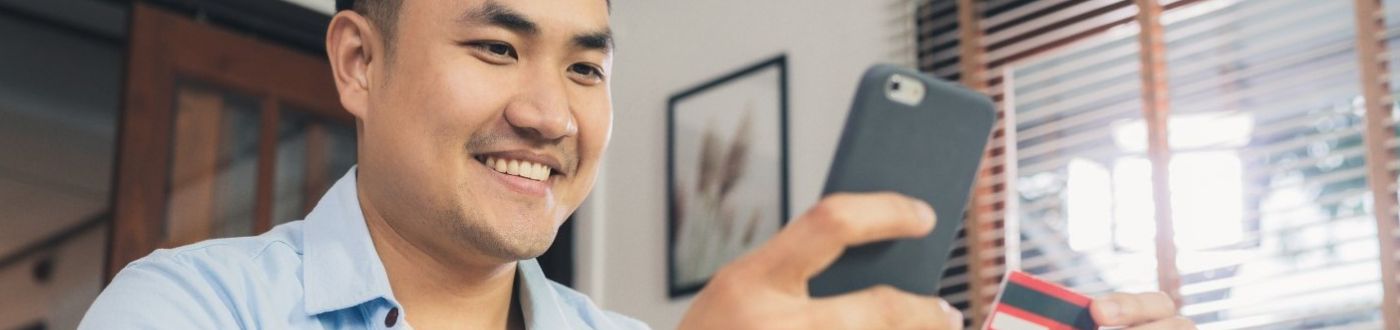 Person entering card details into phone