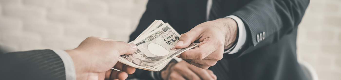 two business men exchanging money