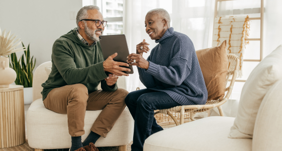 Two People Discussing Details Shown on Device