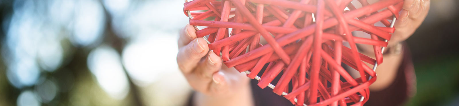 Person holding wicker heart