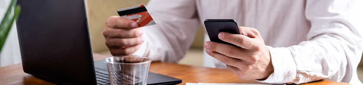 Man holding Phone Debit Credit Card