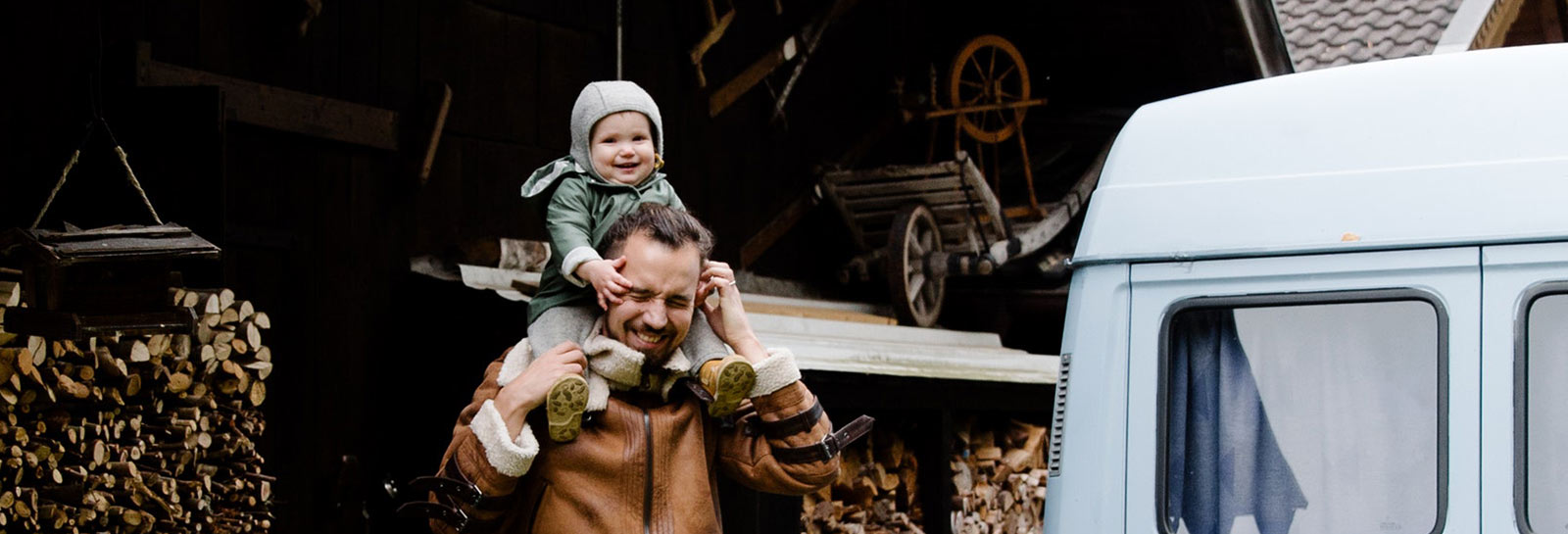 Dad giving son ride on his shoulders.