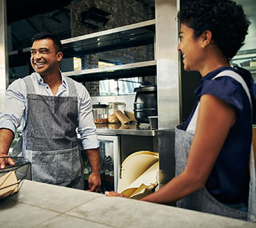 Two people working at a restaurant.