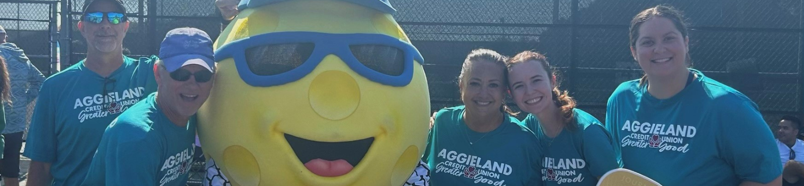 Header image with volunteers from Aggieland Credit Union